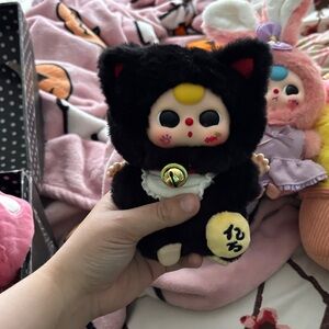 Black Furry Doll with Yellow and Red Accents